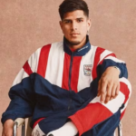 Piero Hincapié modela prendas de la nueva colección retro de Arsenal y Adidas inspirada en los años 90.